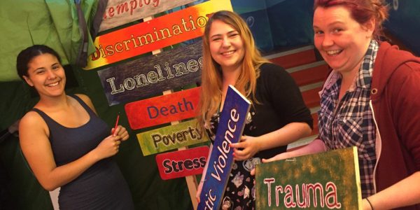 Women golding signs describing mental illnesses