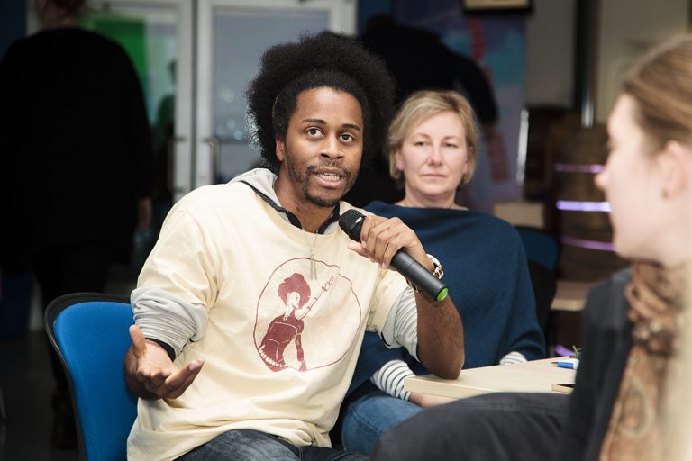 An audience member asks a question during an evening talk