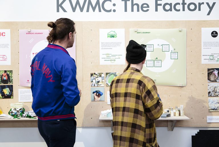 Visitors read exhibition panels in the Ways of Working exhibition
