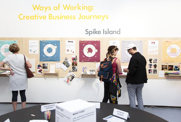 Visitors read exhibition panels in the Ways of Working exhibition