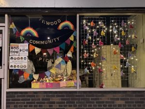 The display of knitted Hearts in the window of re:store on Filwood Broadway